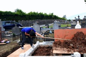 Filling a grave in Armagh.